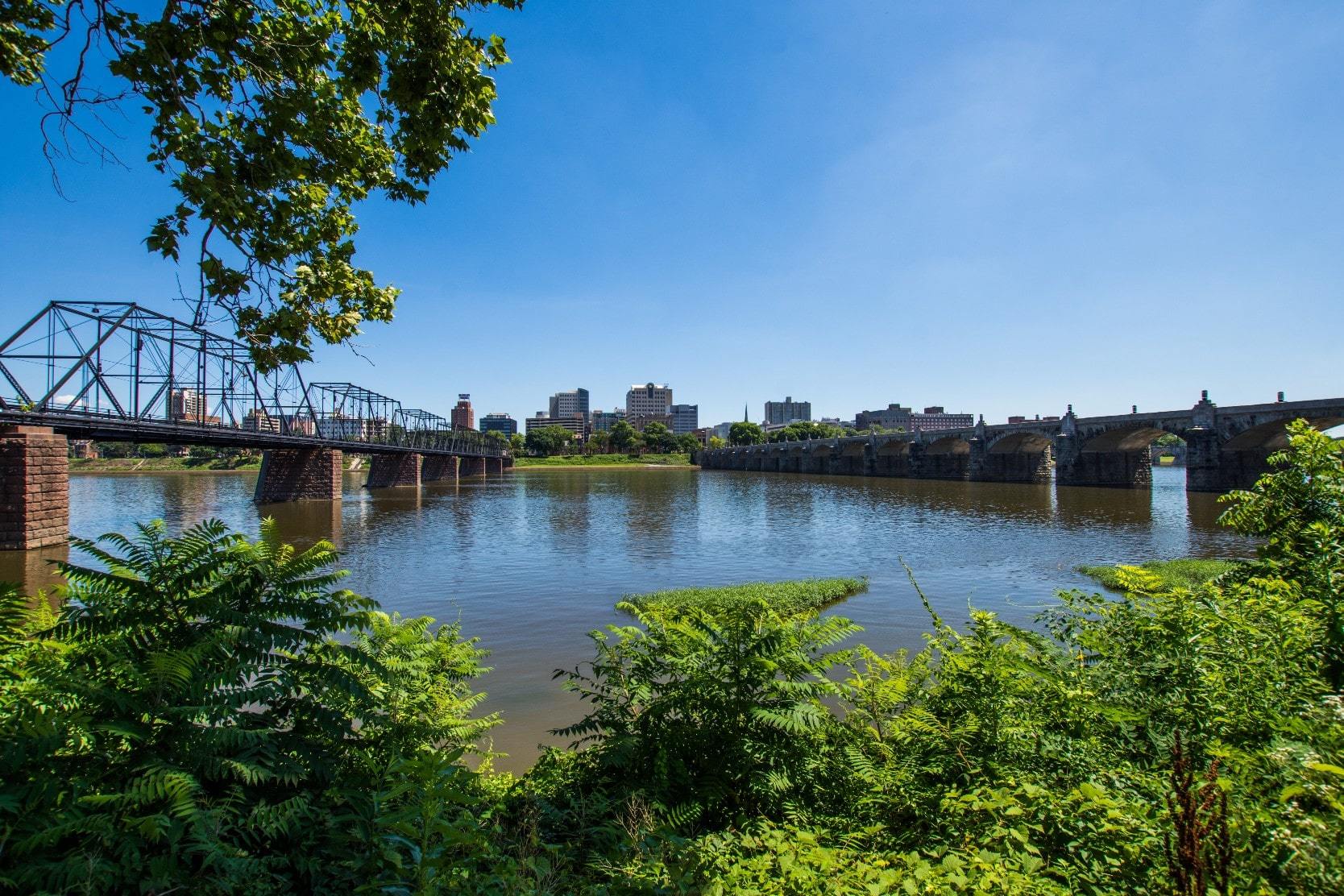 View of the Susquehanna River and Harrisburg skyline with waterfront real estate in Dauphin County, PA